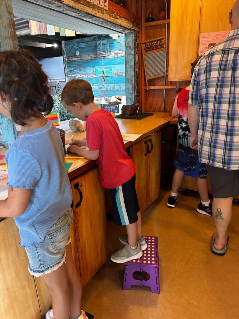 Image of children assembling crafts at the Backyard Science program at the Bishop Museum of Science and Nature.