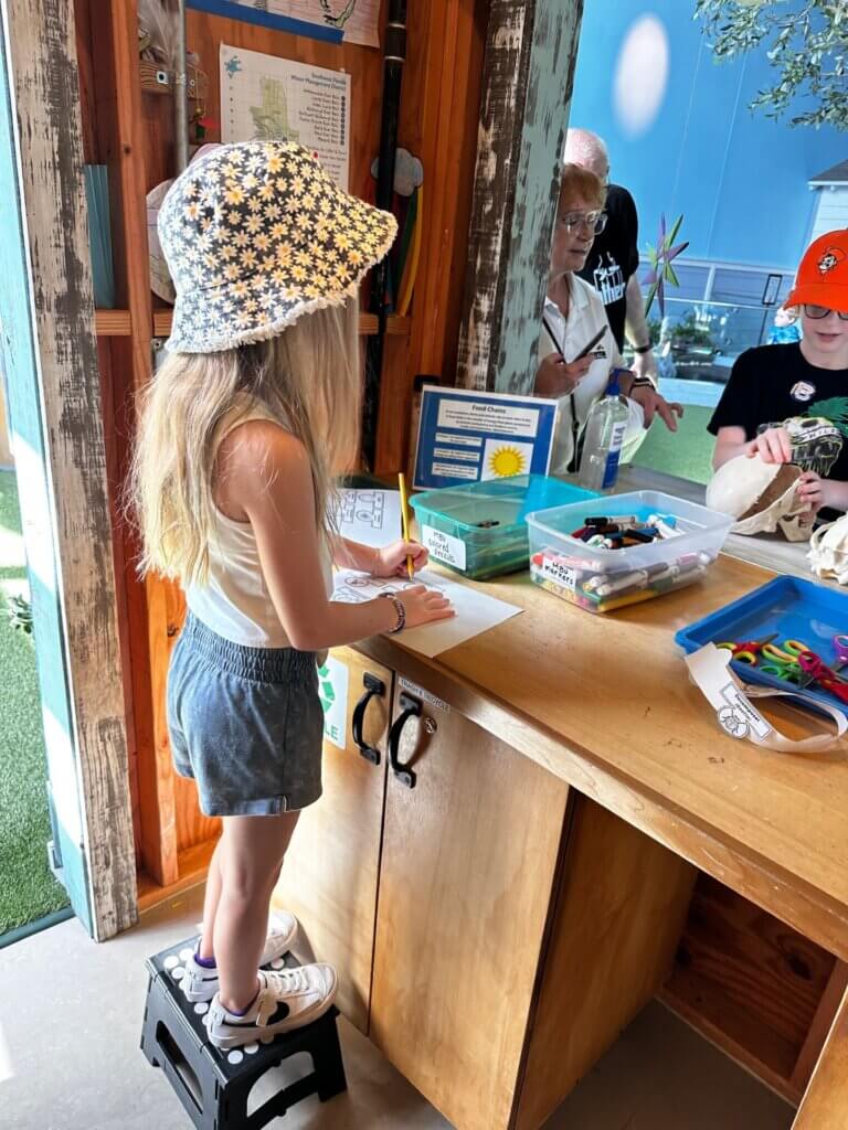 Image of children assembling crafts at the Backyard Science program at the Bishop Museum of Science and Nature.