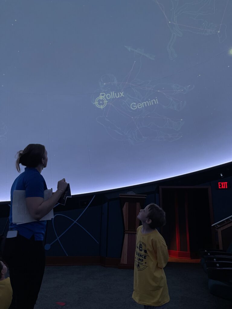 Counselor and camper inside the Planetarium.