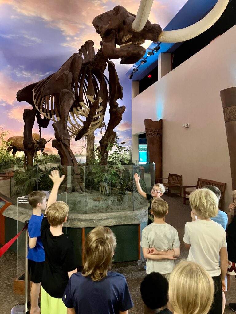 Campers in front of Pricilla the Mastodon.