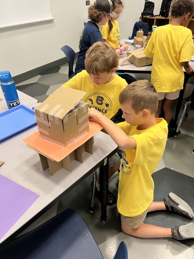 Campers working on STEAM projects.