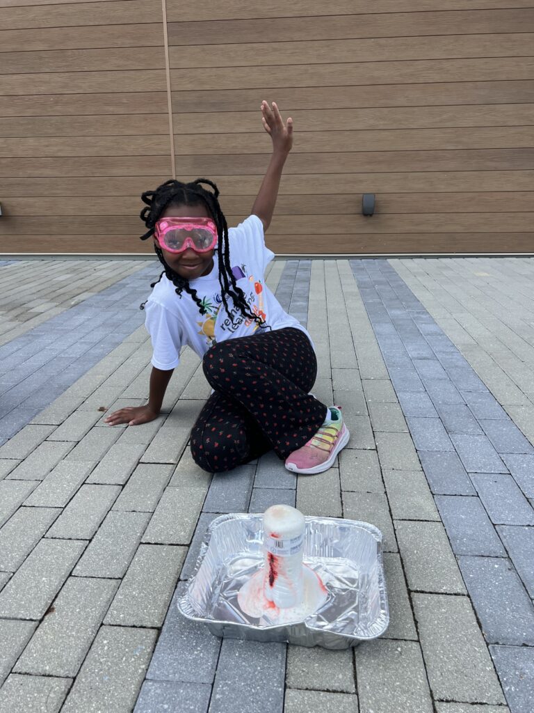 Camper watching the chemical reaction of her science experiment.